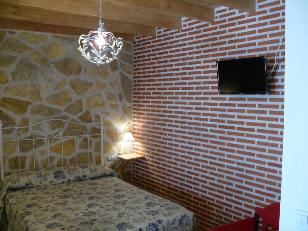 A bed or beds in a room at Abadía del Marqués de Avila