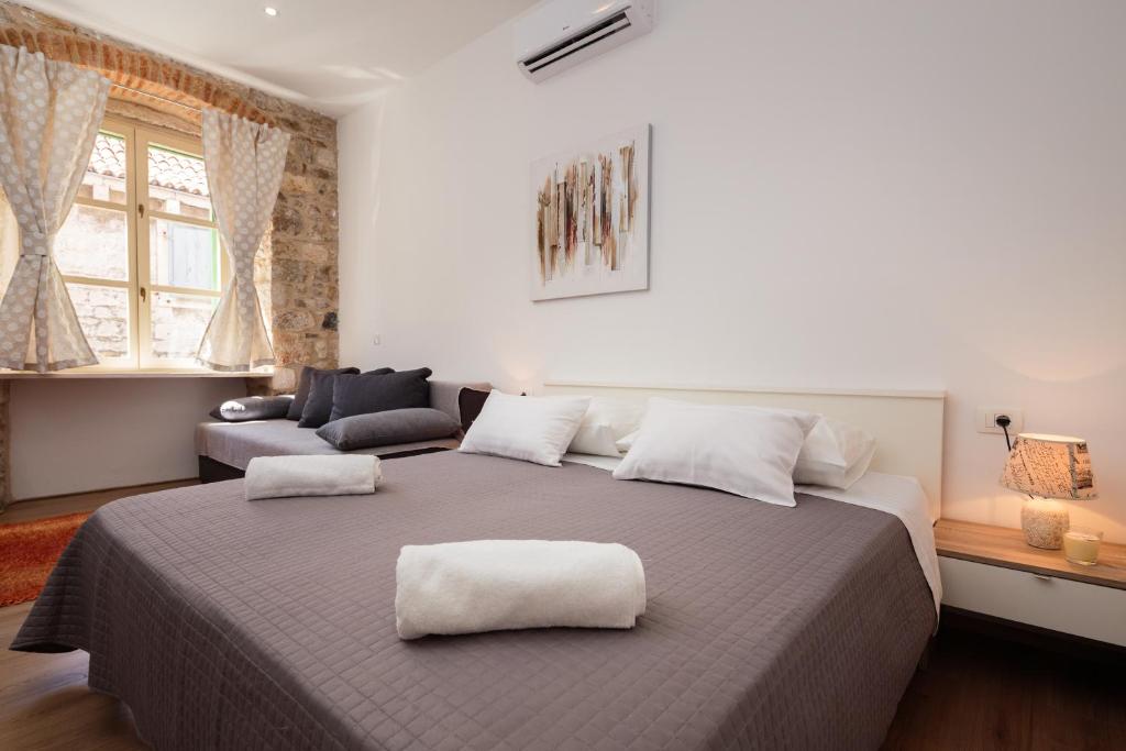 a bedroom with a large bed with two white pillows at Lux Cindro Studio in Split Center in Split