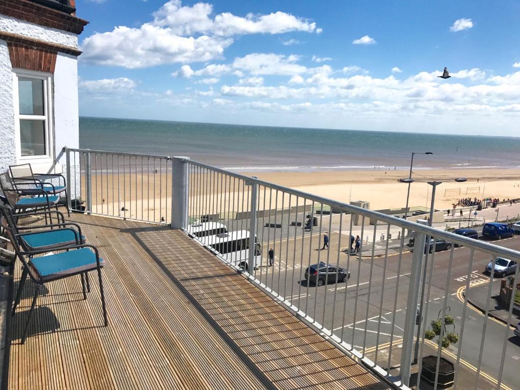 a balcony with chairs and a view of the beach at Apartments @52 in Bridlington