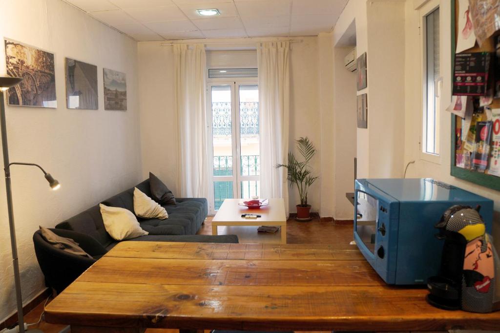 a living room with a couch and a table at Penthouse duplex in center in Seville