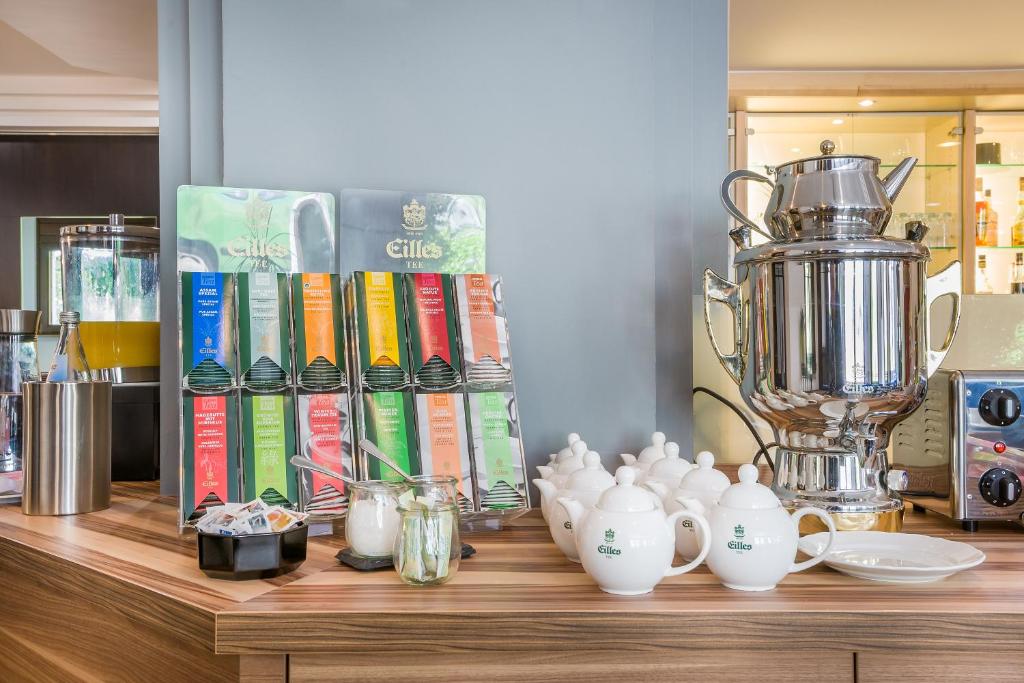 a wooden counter with books and a trophy on it at Hotel Rega Stuttgart in Stuttgart