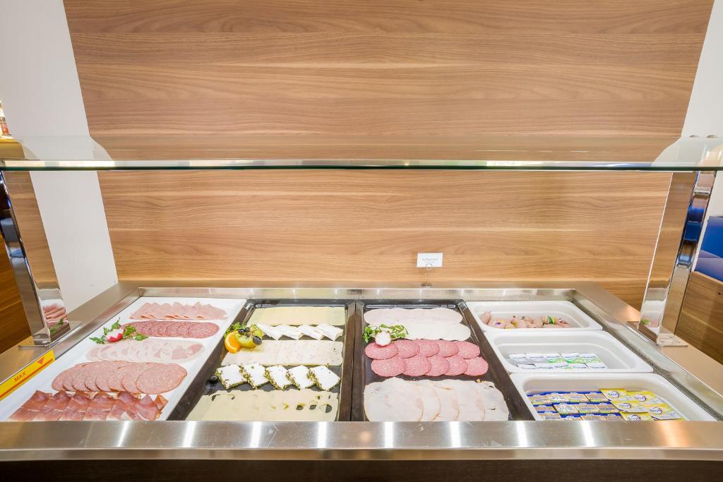 a display case filled with different types of meat at Hotel Rega Stuttgart in Stuttgart
