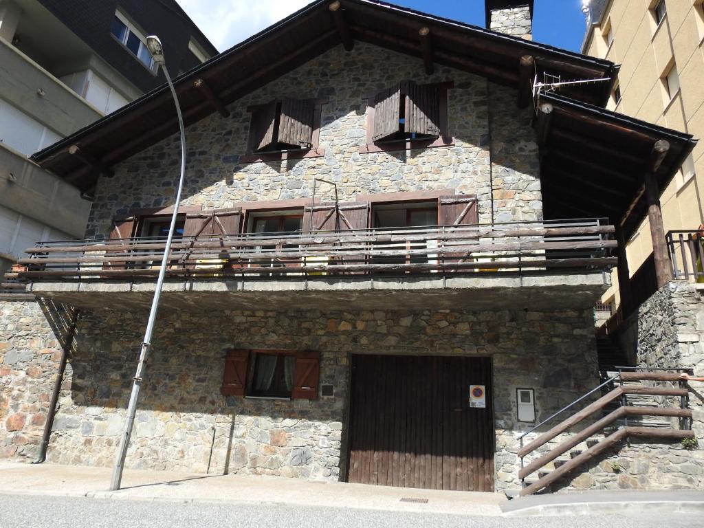 a building with a balcony on the side of it at Chalet Riba in Arinsal