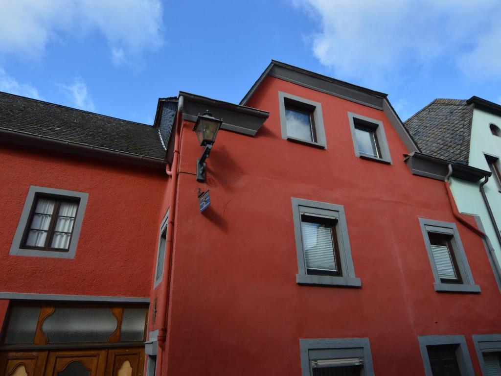 een rood gebouw met ramen en een blauwe lucht bij Charming Holiday Home in Neumagen Dhron in Neumagen-Dhron