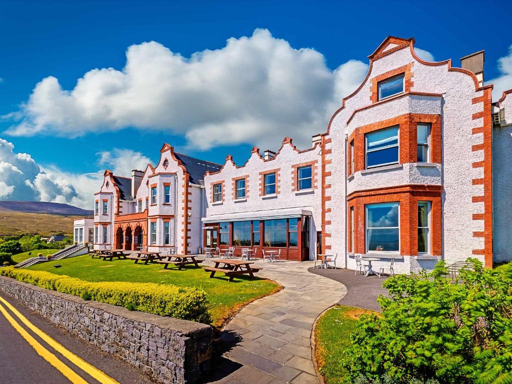 a large brick building with a view of a city at Mulranny Park Hotel in Mulranny