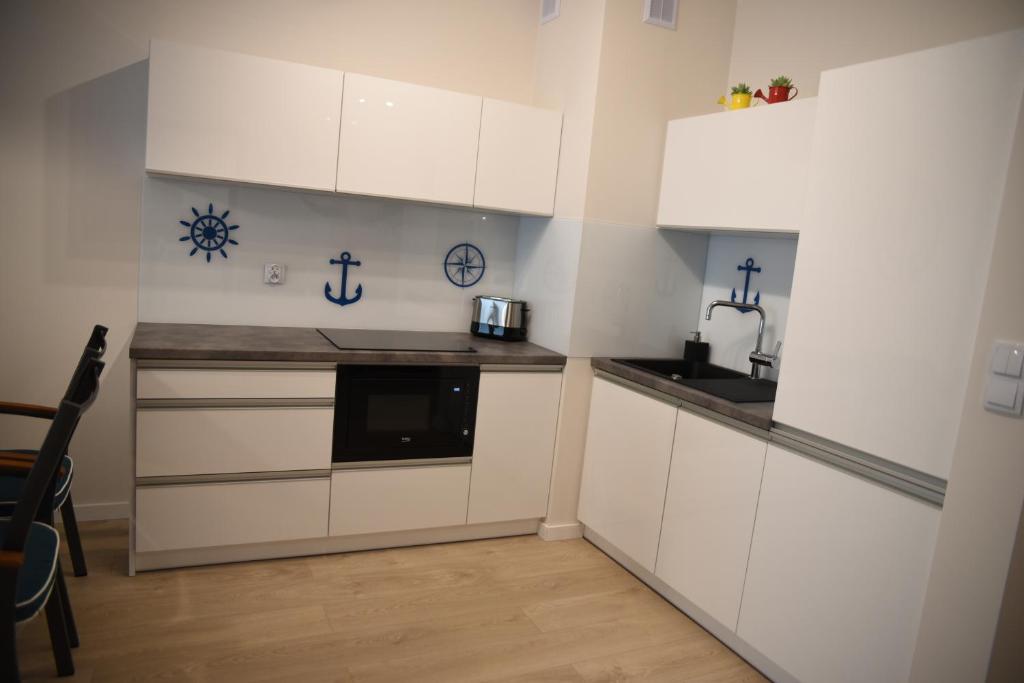 Kuchyňa alebo kuchynka v ubytovaní Apartament Szmaragdowy