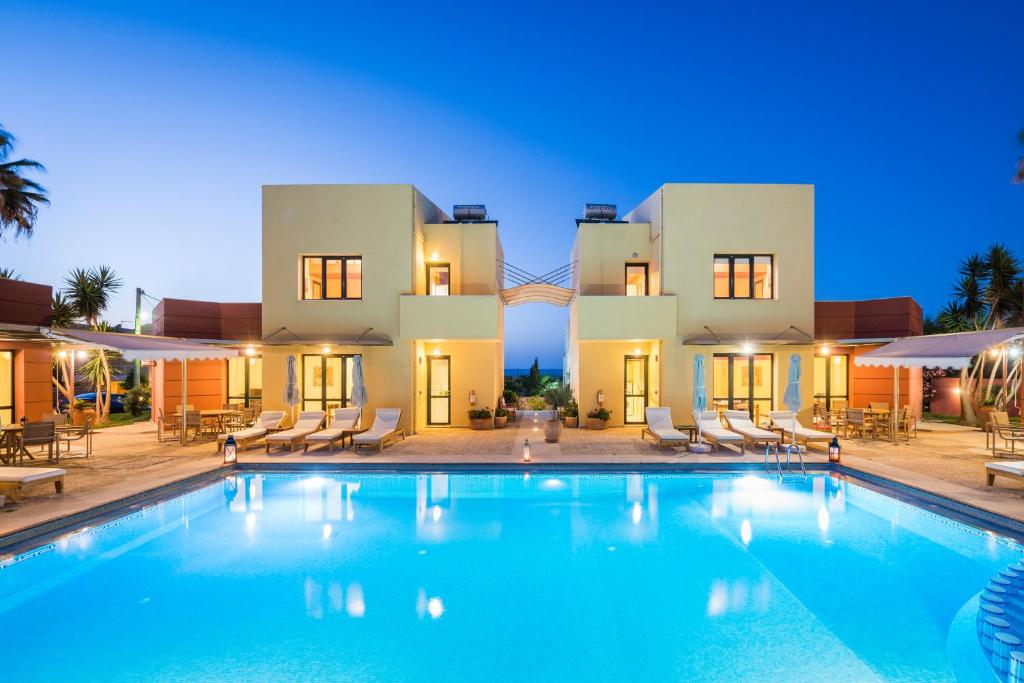 a large swimming pool in front of a villa at Daphnis Villas in Maleme