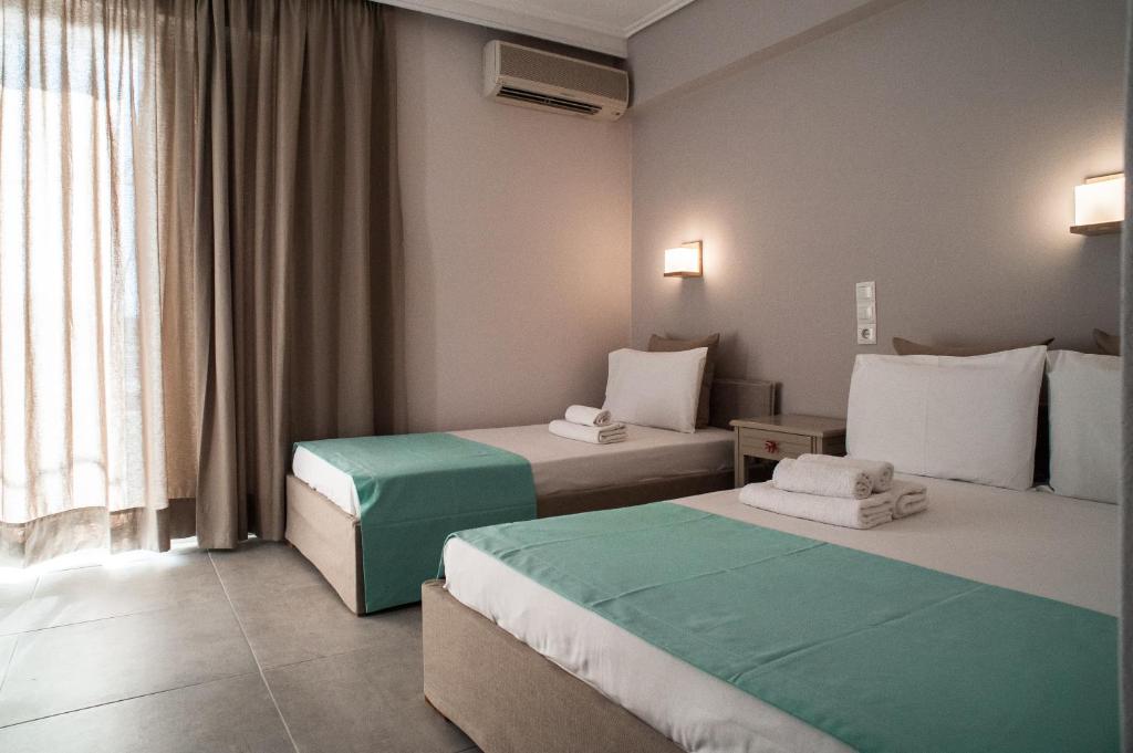 Łóżko lub łóżka w pokoju w obiekcie Kochili Apartments