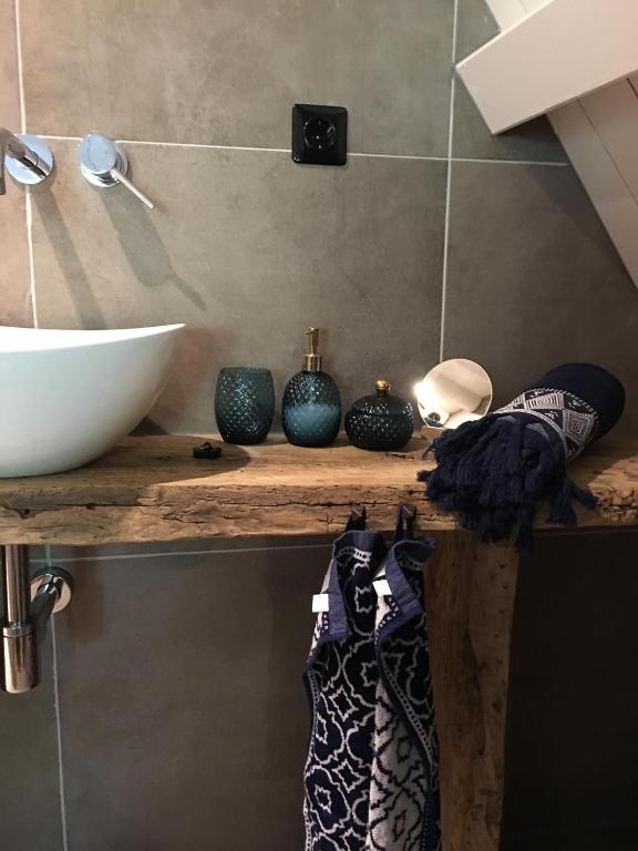 a counter with a sink and some vases on it at bednextdoor in Middelburg