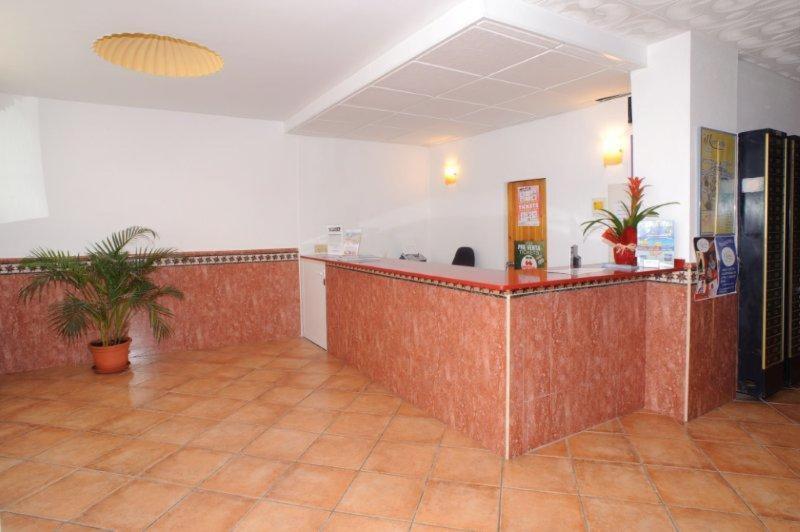 a large room with a counter in a building at Hostal Montaña in San Antonio