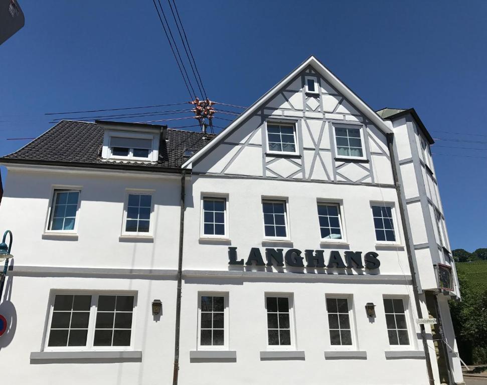 a white building with a sign on it at Hotel Langhans in Abstatt