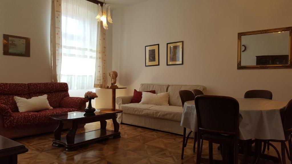 a living room with a couch and a table at Centar old town, with parking place in Pula