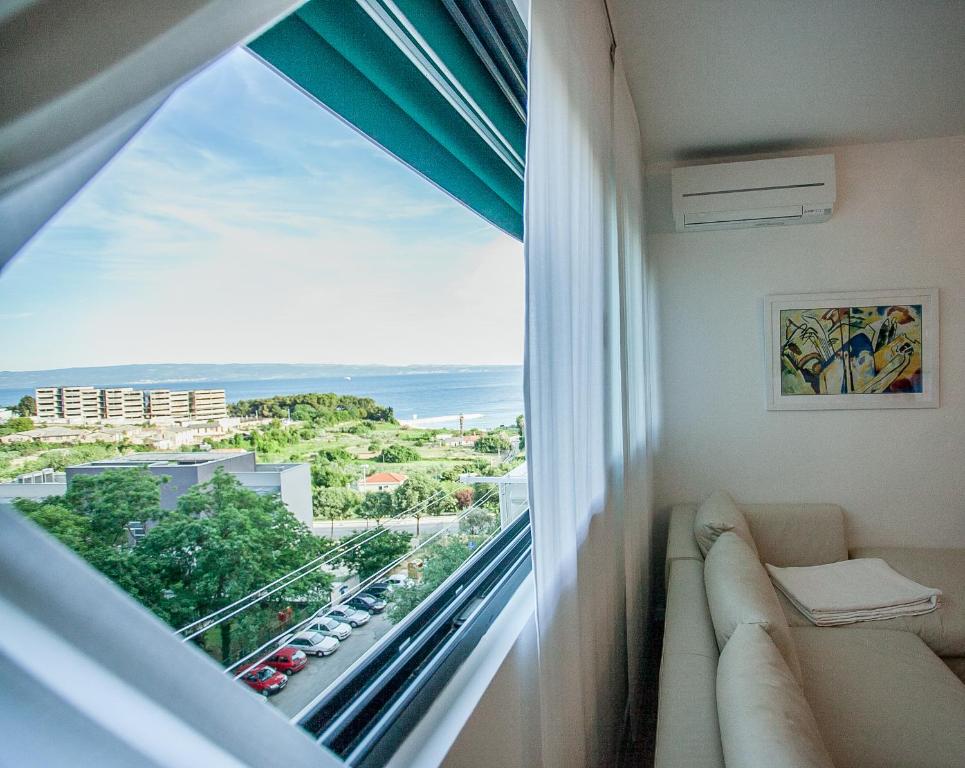 a room with a window with a view of the ocean at Apartment Laura in Split