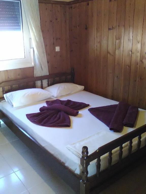 A bed or beds in a room at Nektaria on the Beach