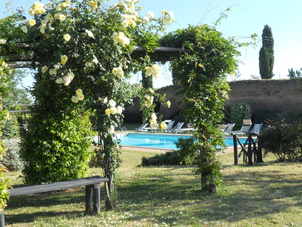 a garden with a swimming pool and roses at Locanda Rosati in Orvieto