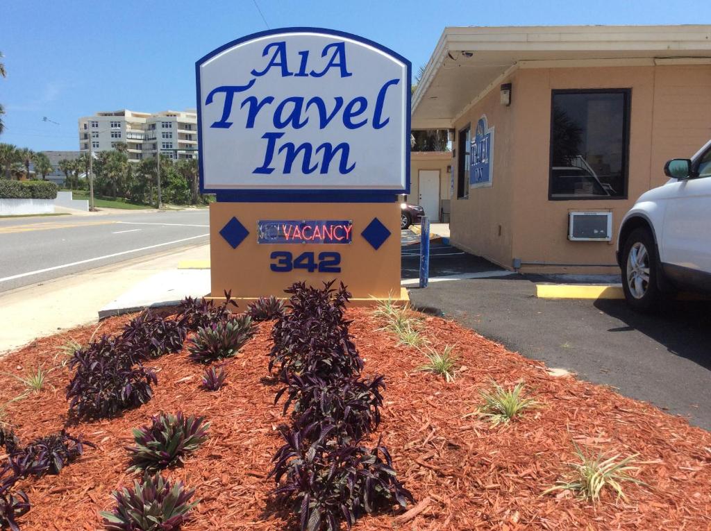 a sign for azona travel inn in a yard at A1A Travel Inn in Ormond Beach