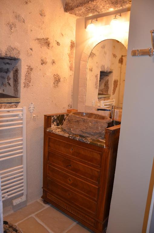 a bathroom with a wooden dresser in a room at Studio Moncoeur in Le Blanc