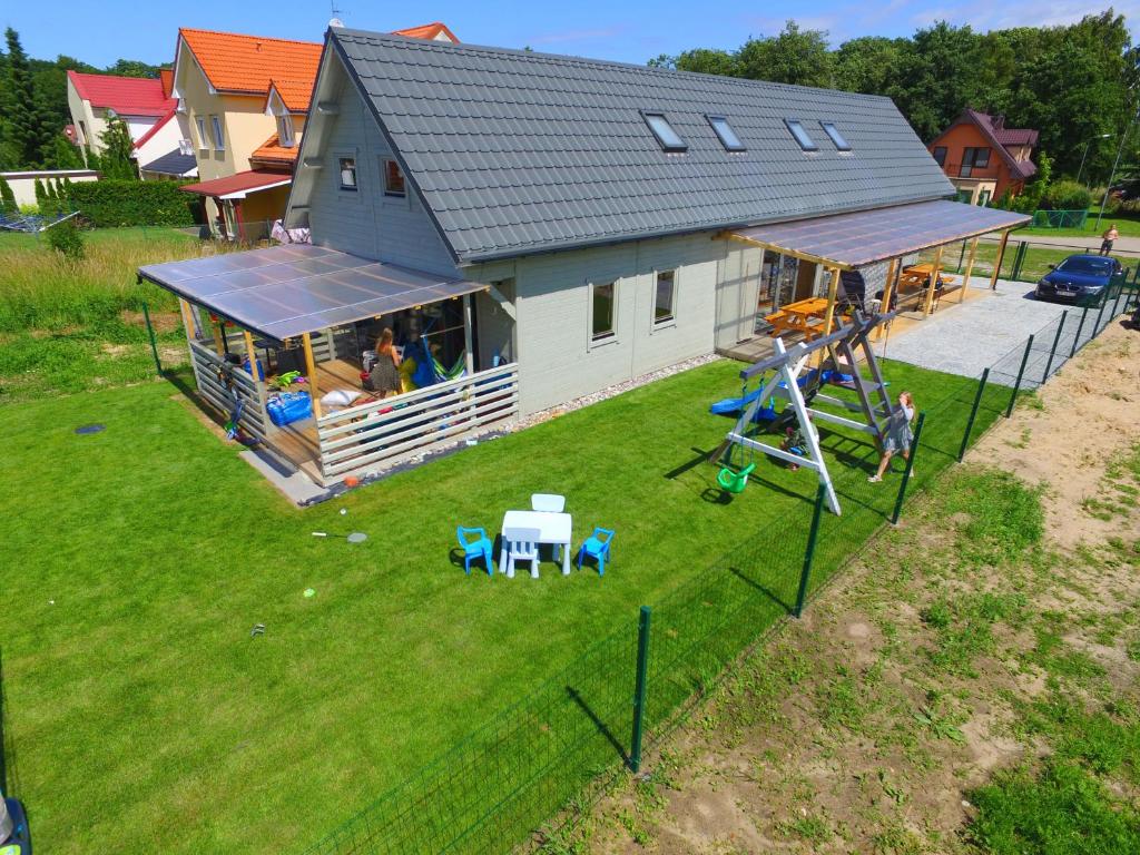 an overhead view of a house with a playground at Kapitanskie Domki in Trzęsacz