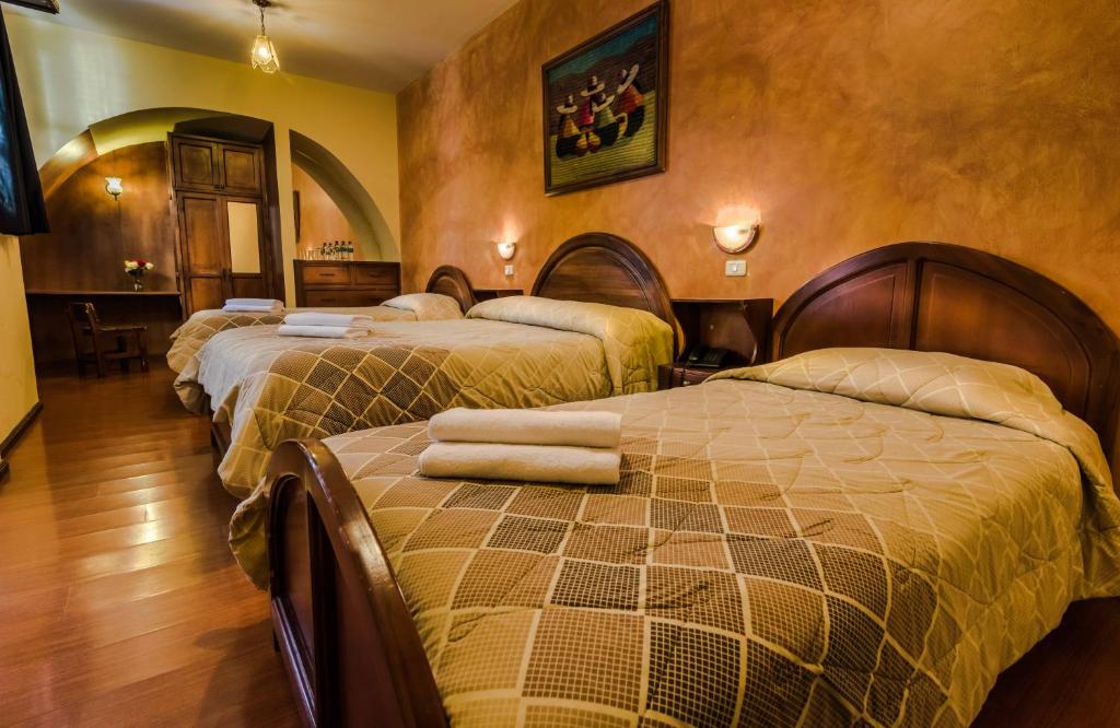 Postel nebo postele na pokoji v ubytování Hotel San Francisco De Quito