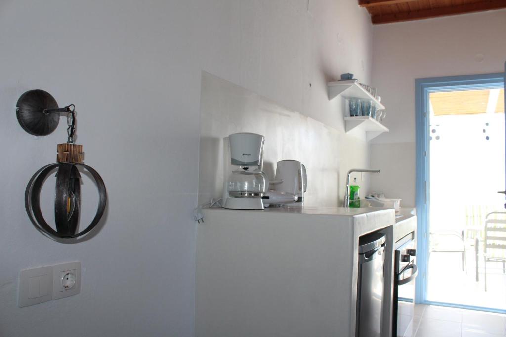 a kitchen with white walls and a white counter top at Studios Betty in Plaka Milou