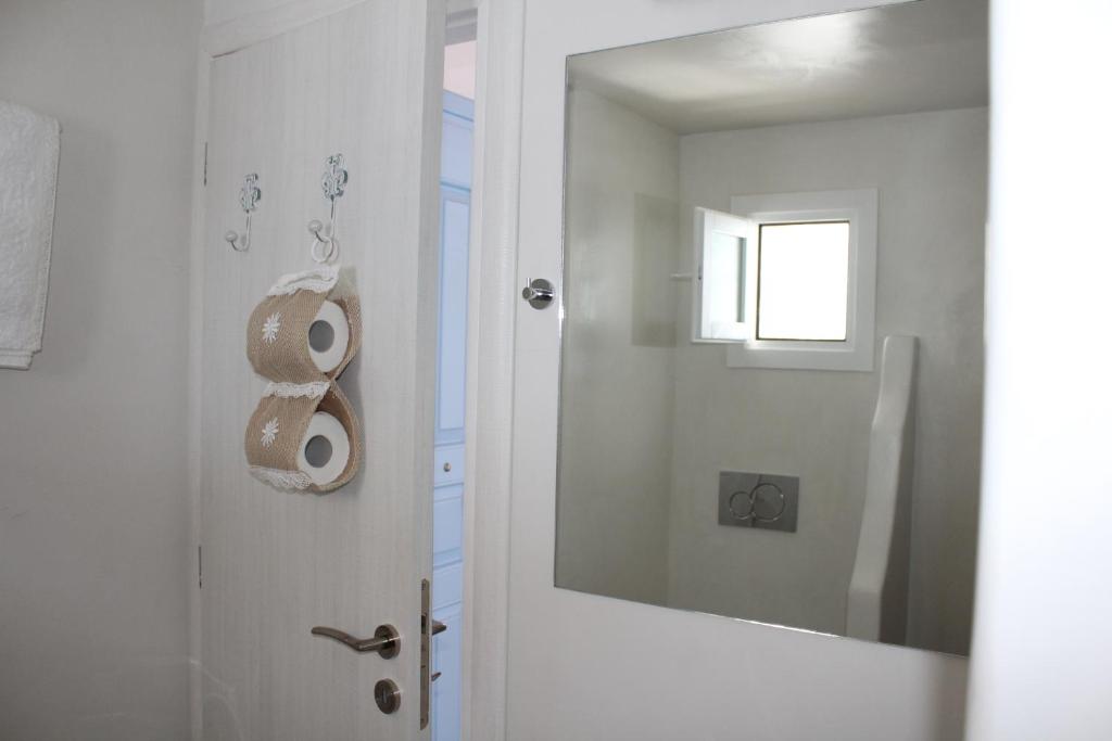 a bathroom with a toilet paper roll on the door at Studios Betty in Plaka Milou