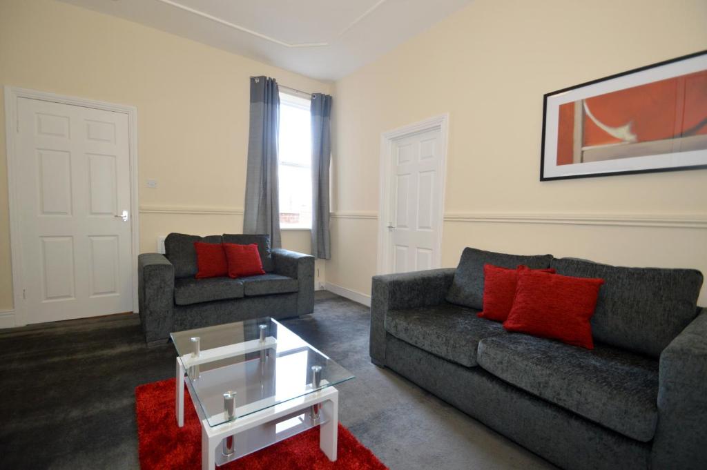a living room with two couches and a coffee table at Hyde Park Apartment in Gateshead