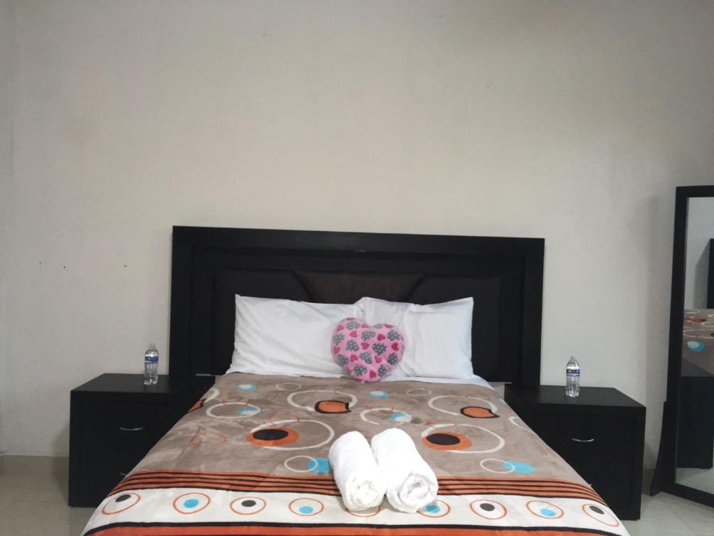 Postel nebo postele na pokoji v ubytování Hotel Coatlicue