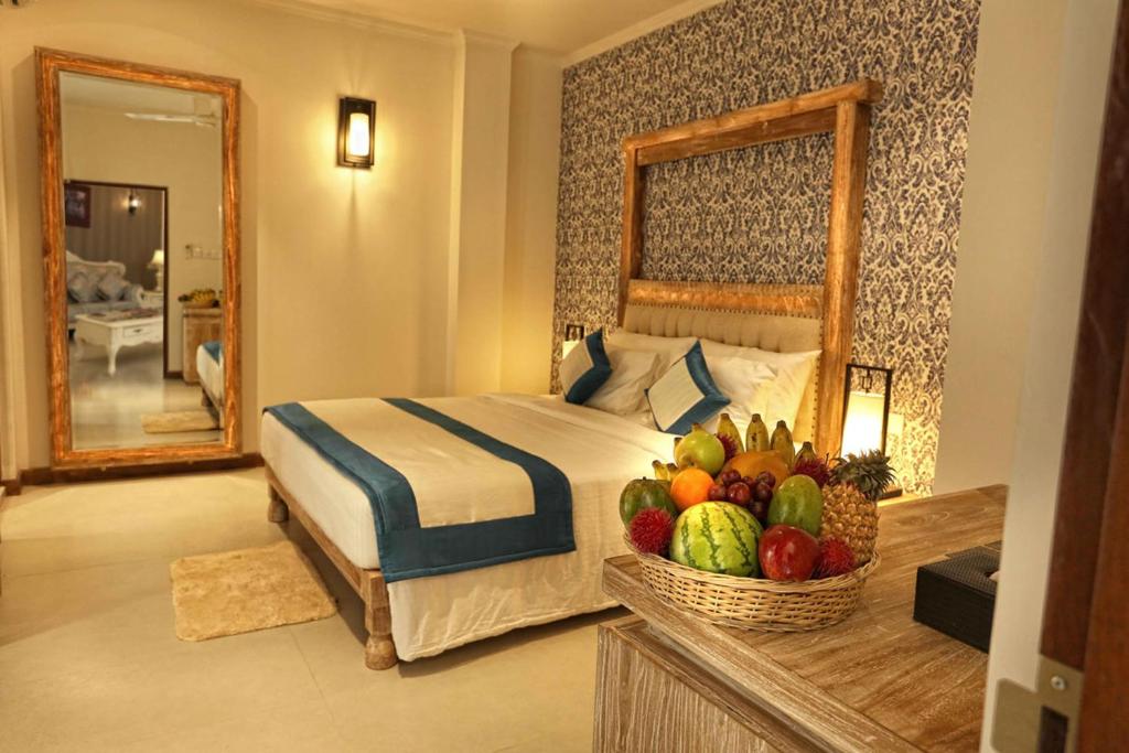 a bedroom with a bed and a basket of fruit at Rivora Residence in Kandy