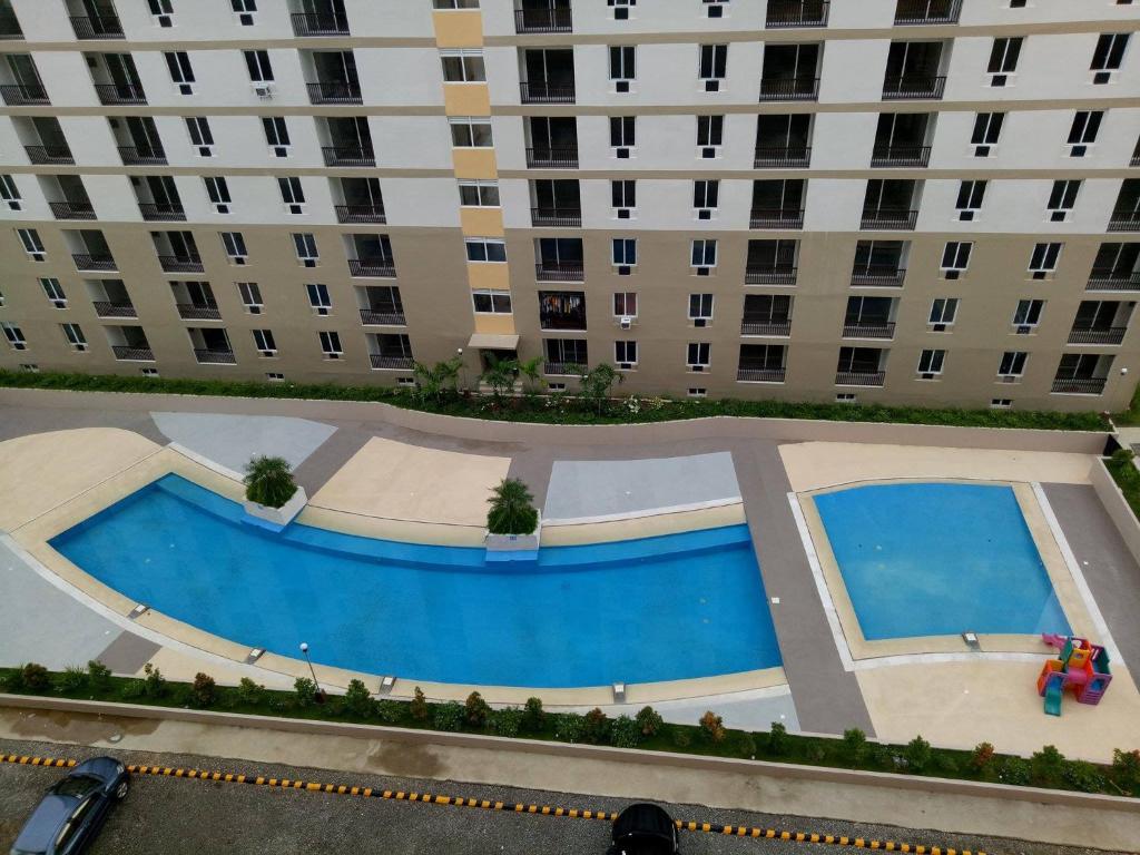 an overhead view of a large apartment building with a pool at Cebu-Mactan Condo in Mactan
