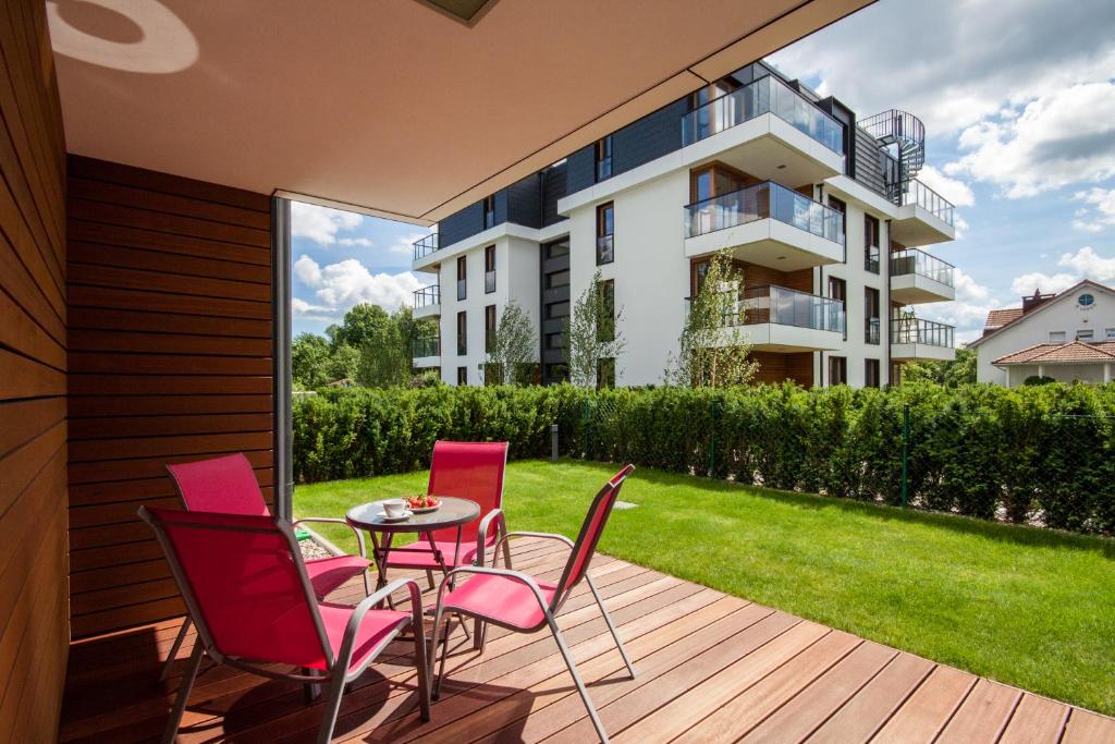 eine Terrasse mit einem Tisch und Stühlen sowie ein Gebäude in der Unterkunft Apartament di Mare in Danzig