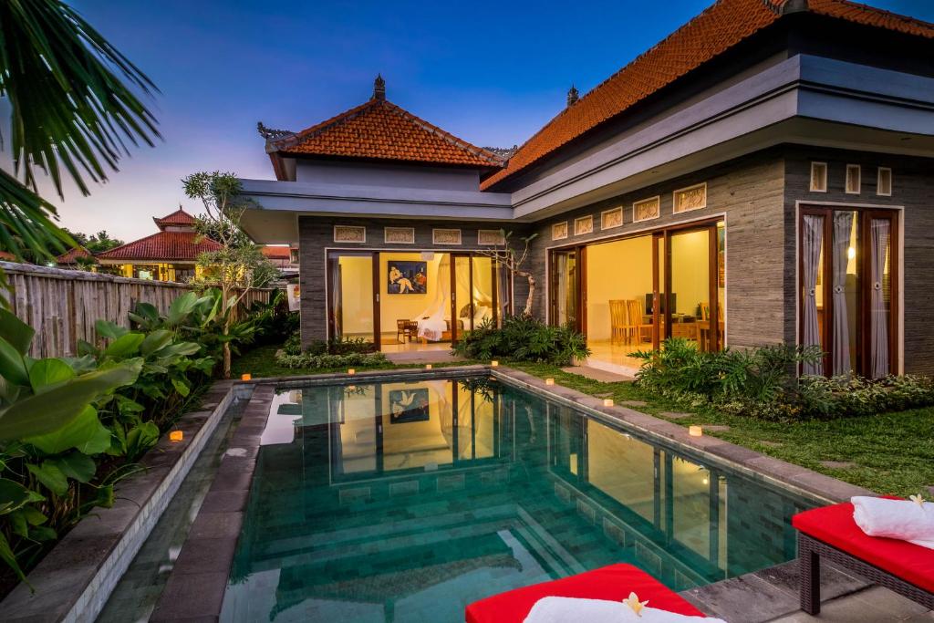 a house with a swimming pool in front of it at Laba Ubud Villa in Ubud