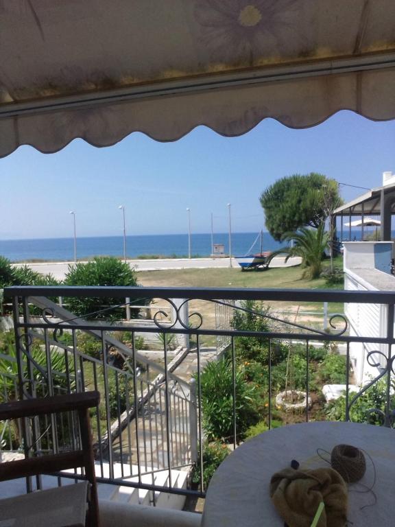 a view of the beach from a balcony at SeeTheSea Apartment Kanali in Preveza