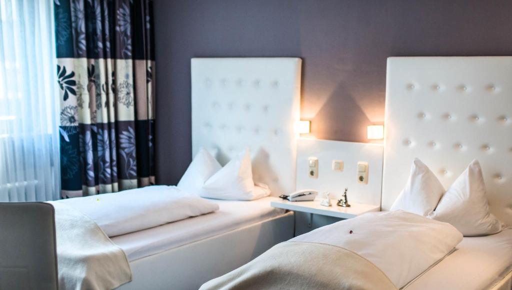 Postel nebo postele na pokoji v ubytování Hotel Domizil
