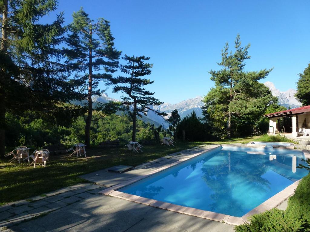 a swimming pool in the backyard of a house at Boustigue Hotel in Corps