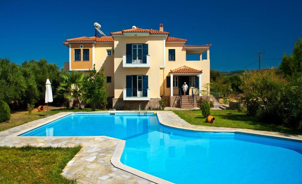 a villa with a swimming pool in front of a house at Marita in Lisvórion