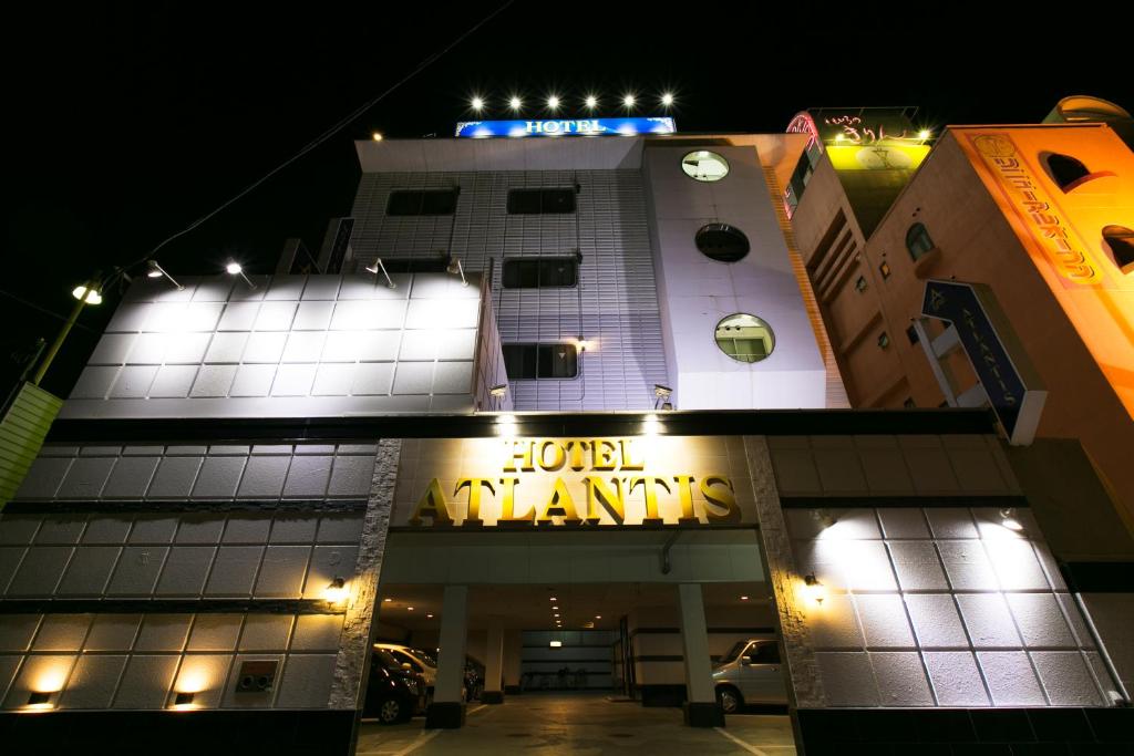 a building with a sign that reads illegal organizations at night at Hotel Atlantis Higashi Osaka (Adult Only) in Osaka