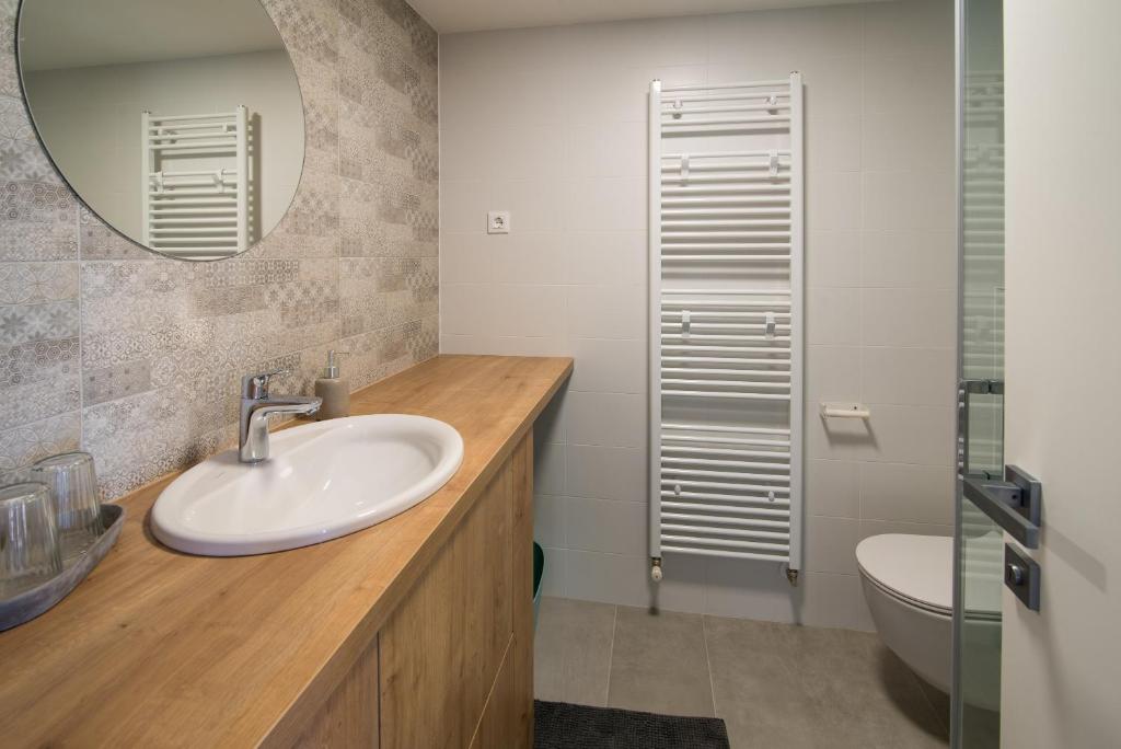 łazienka z umywalką, lustrem i toaletą w obiekcie Franko & Ana apartments w Krku