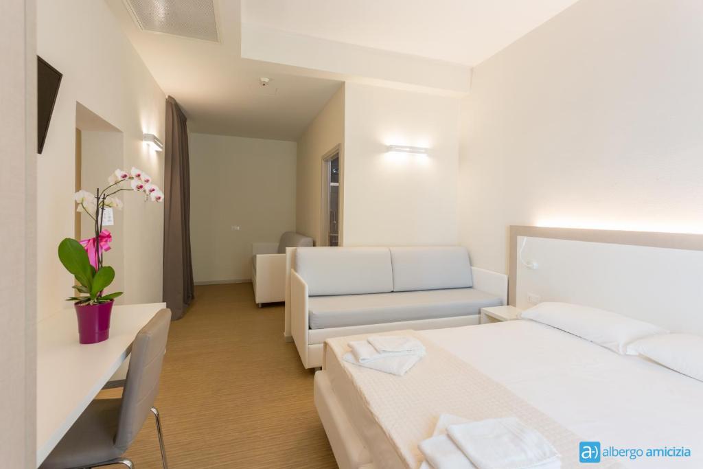Postel nebo postele na pokoji v ubytování Hotel Amicizia