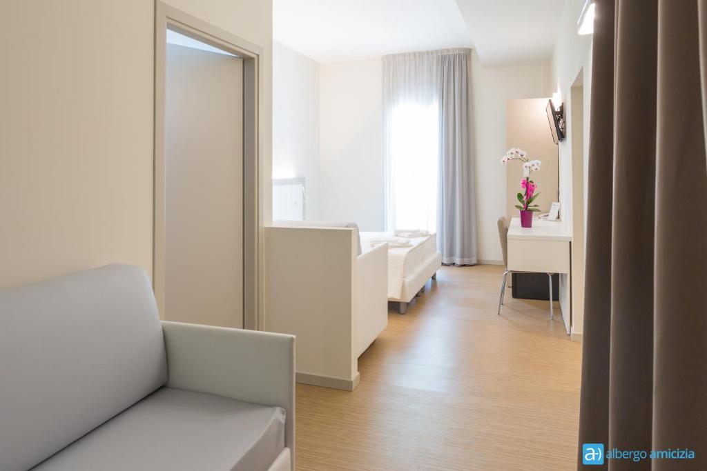 Postel nebo postele na pokoji v ubytování Hotel Amicizia
