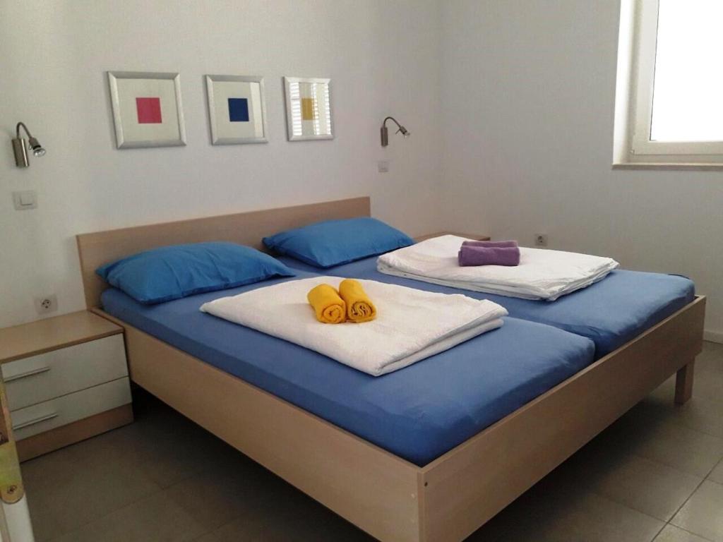 a bedroom with a bed with two yellow handles at Apartments Paska Preko in Preko
