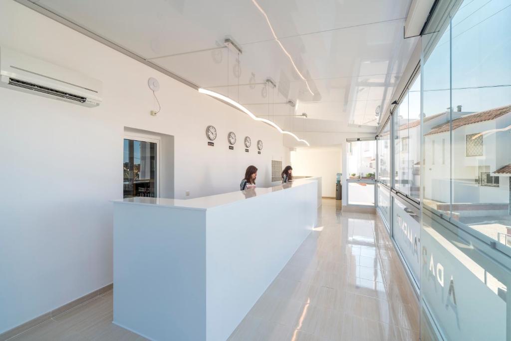 a large white room with a white counter in a building at Apartaments Els Llorers in Lloret de Mar