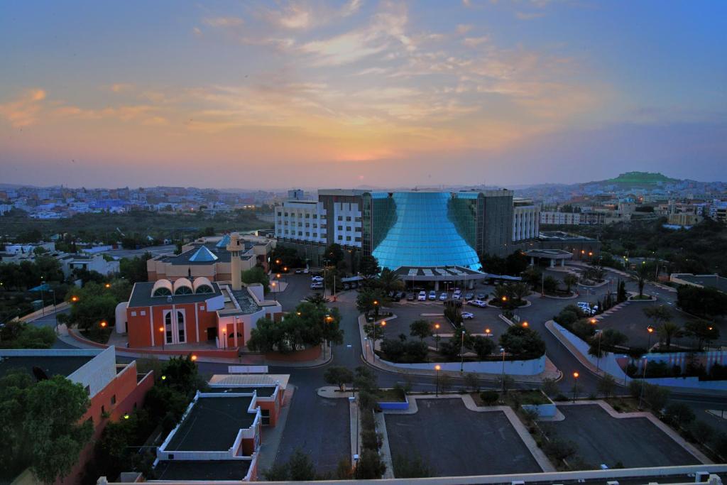an aerial view of a city at dusk at Abha Palace Hotel in Abha