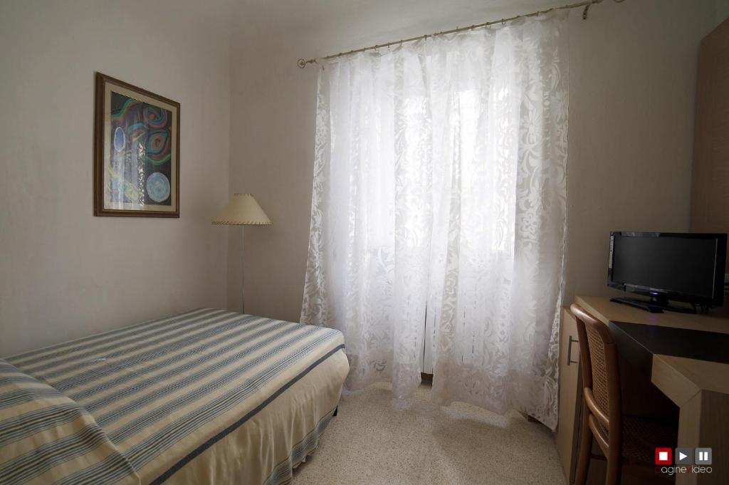 Postel nebo postele na pokoji v ubytování Albergo Giugni