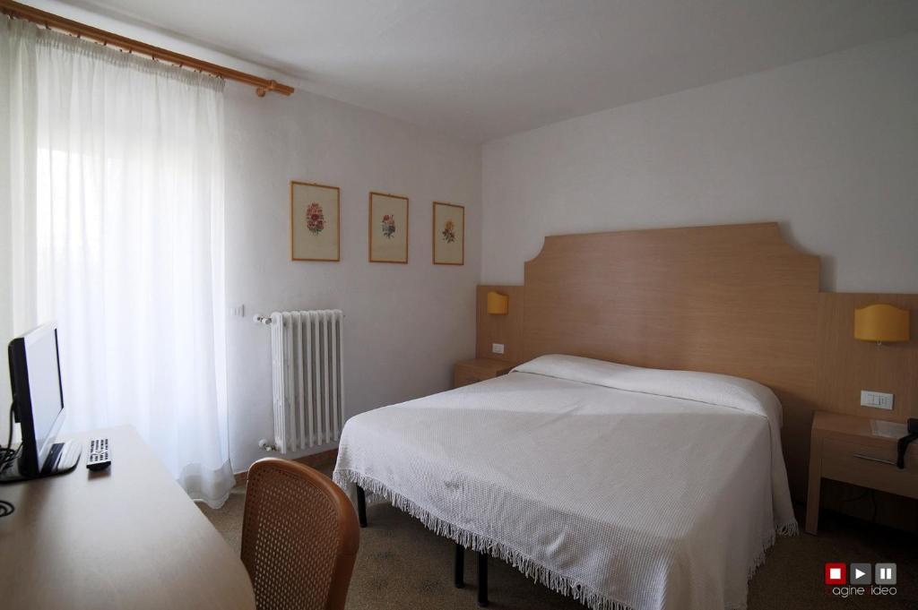 Postel nebo postele na pokoji v ubytování Albergo Giugni