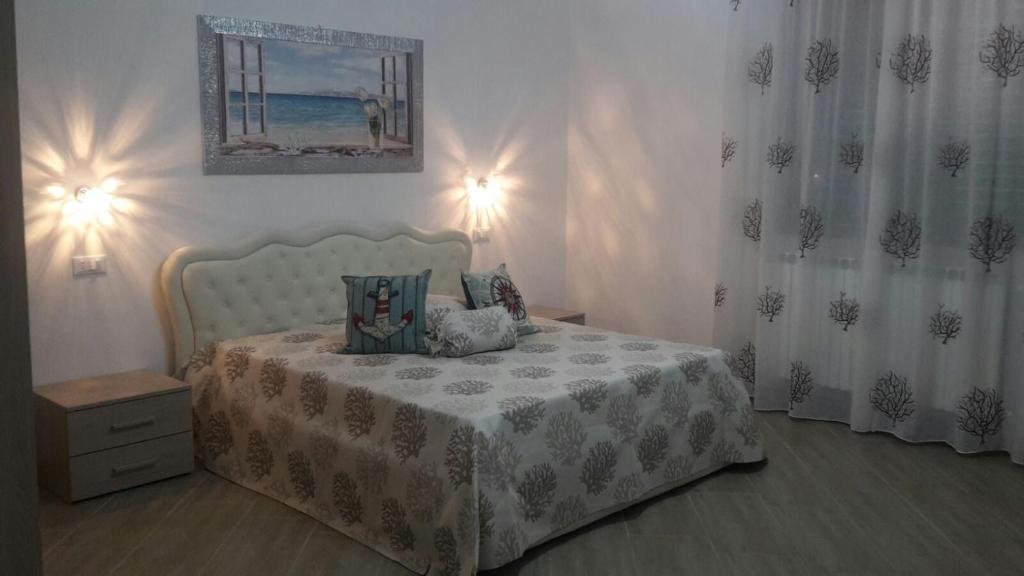 a bedroom with a bed with a white bedspread at Mediterranea Guest House in Porto Cesareo