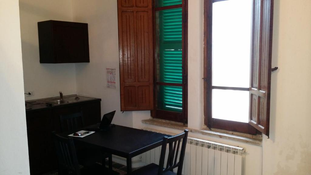 a room with a table and a window with a laptop at Appartamento Esmeralda in Tortoreto Lido