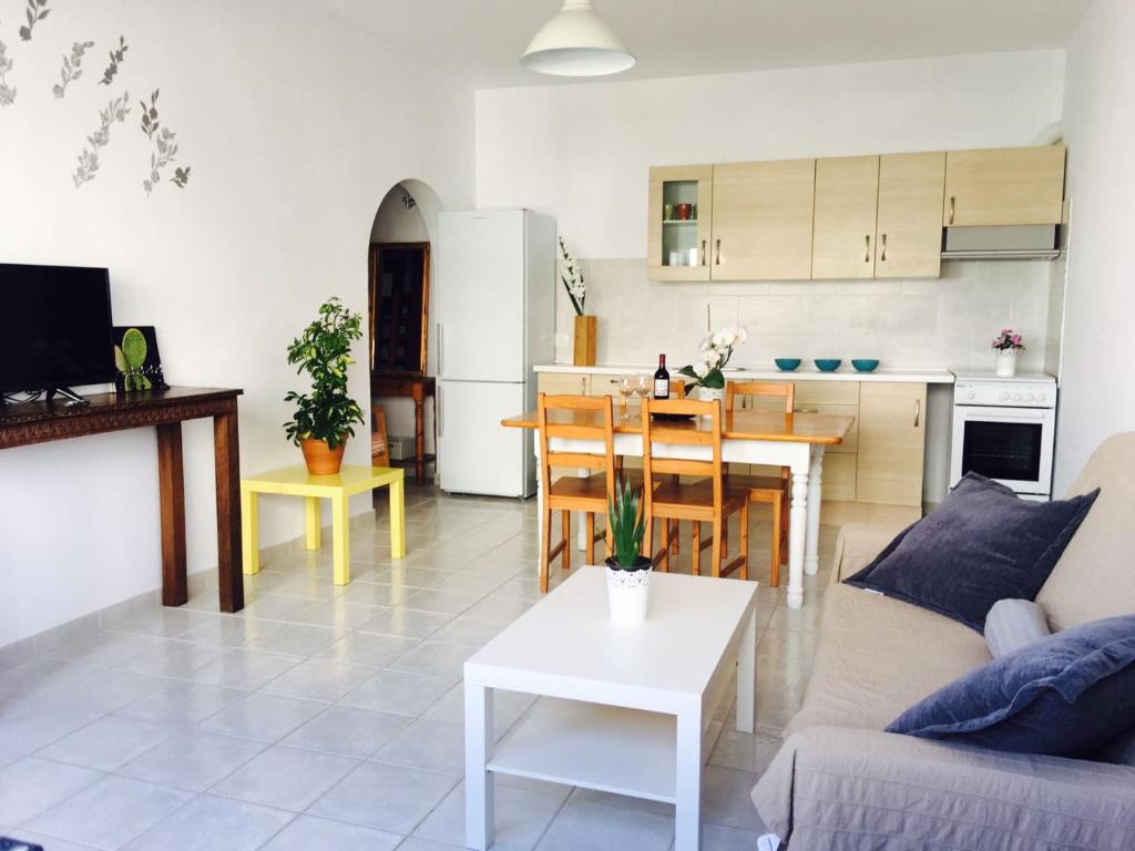 a living room and kitchen with a couch and a table at La Santa Feel Good in La Santa