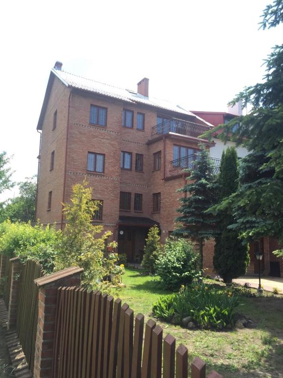 a brick building with a fence in front of it at Nemezis in Ustka