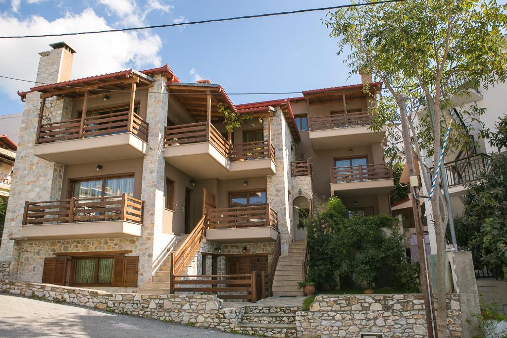 een groot gebouw met houten balkons bij Velia Boutique Apartments in Ouranoupoli