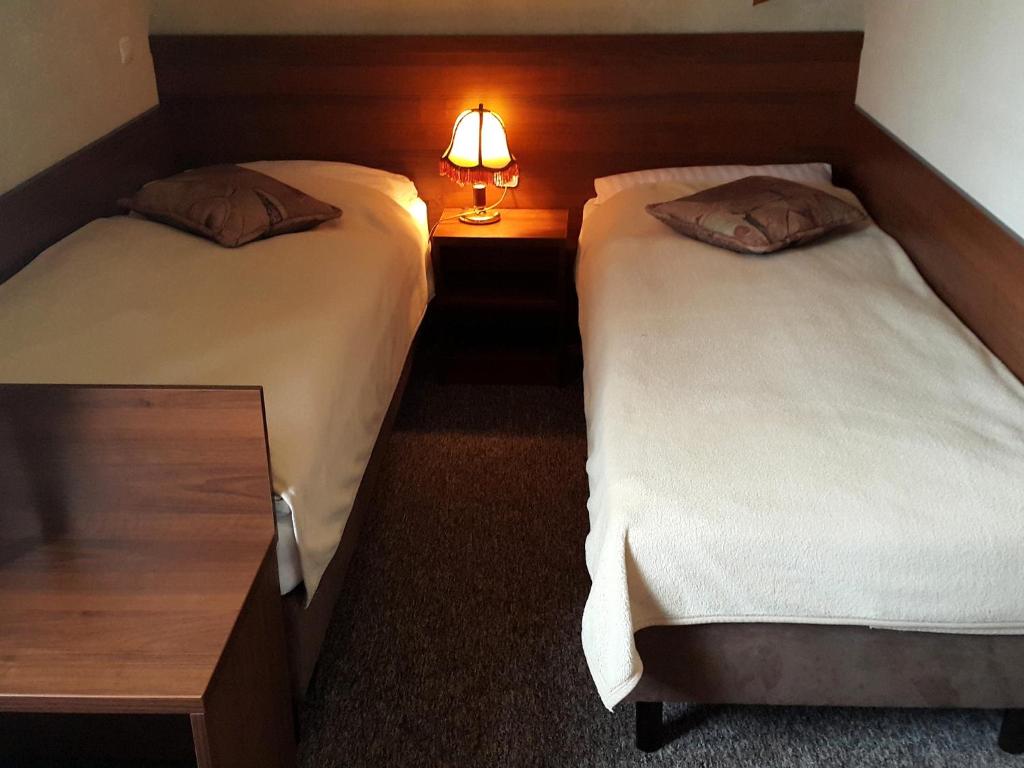 Postel nebo postele na pokoji v ubytování Zajazd Byczy Róg